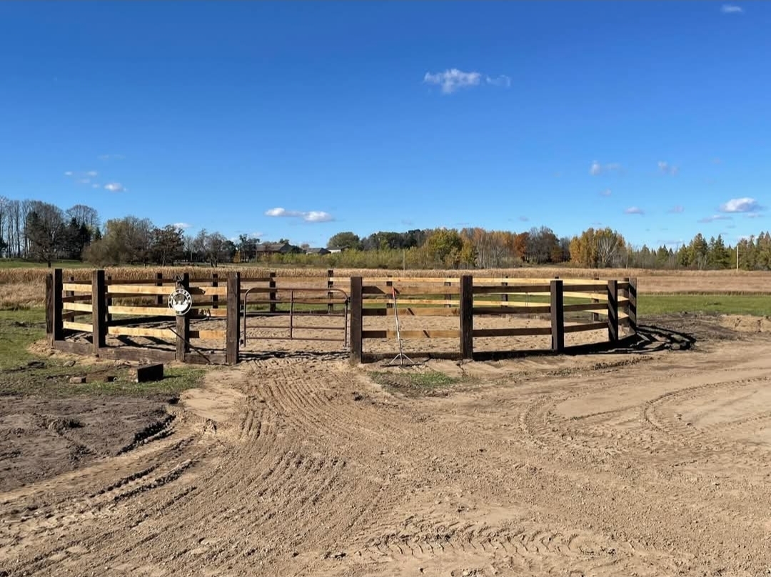 Outdoor round pen under a clear sky